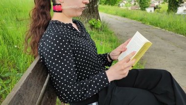 Girl wearing braces and orthodontic headgear in park