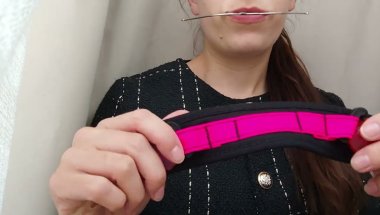 Girl putting on orthodontic headgear braces neckstrap
